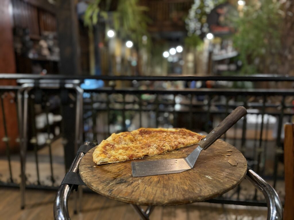 pizza that is half eaten on a pizza board