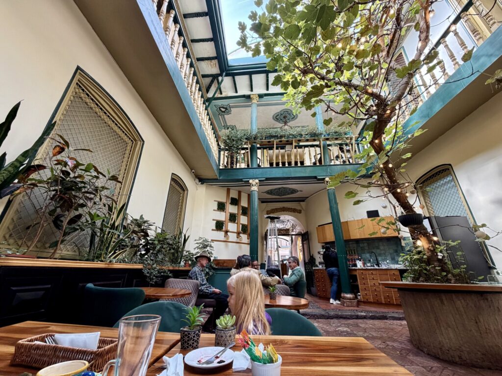 interior of a cafe with people sitting at a table in the background