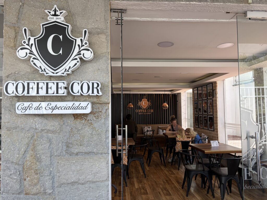 entrance to a restaurant with a family sitting at the table