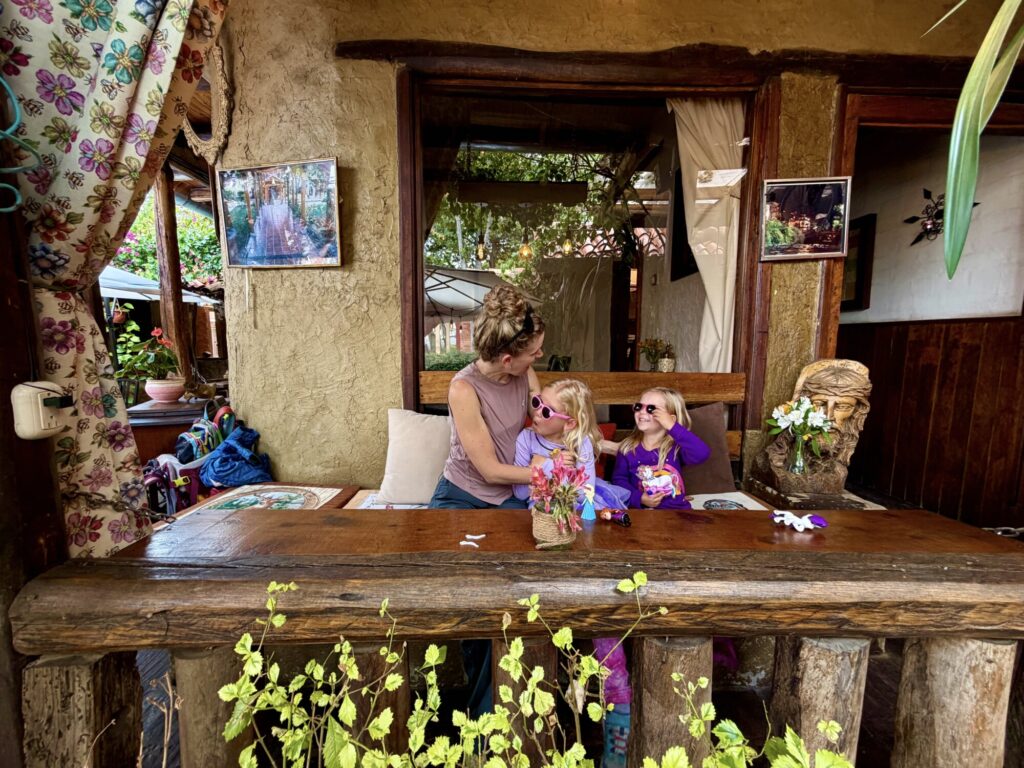 silly playful photo of a mother and two girls at a restaurant