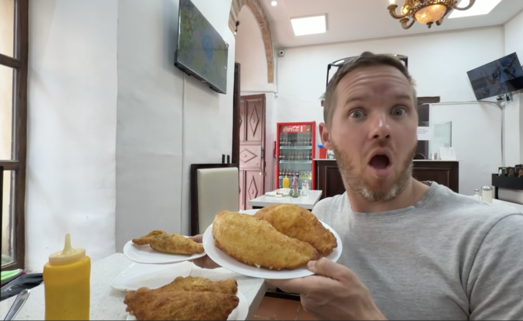 large emapanadas with man making a silly face