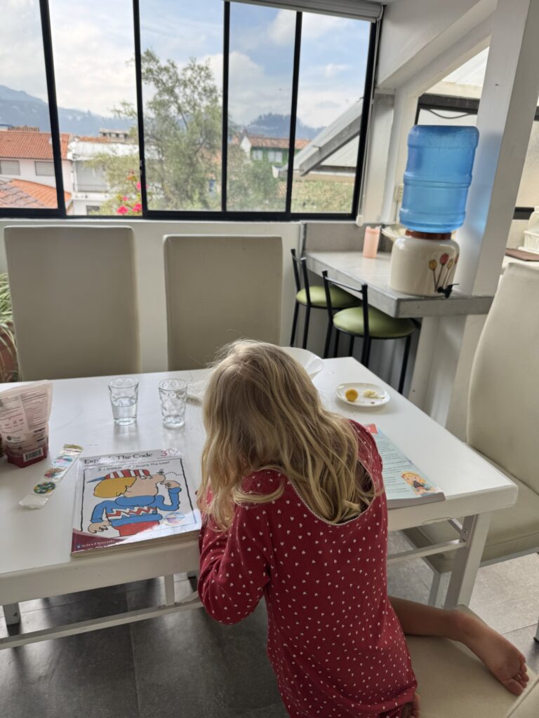 girl doing homework at a kitchen table