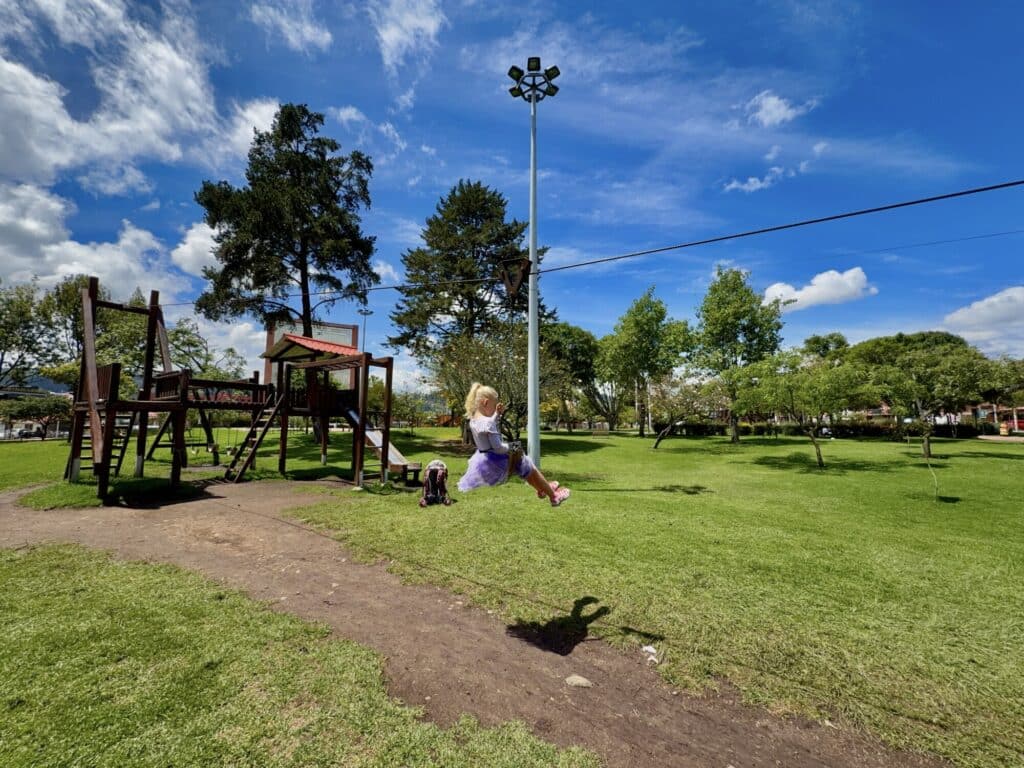 a girl on a zipline at a playground