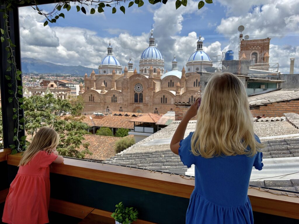 two girls looking at a cathedral with blue domes