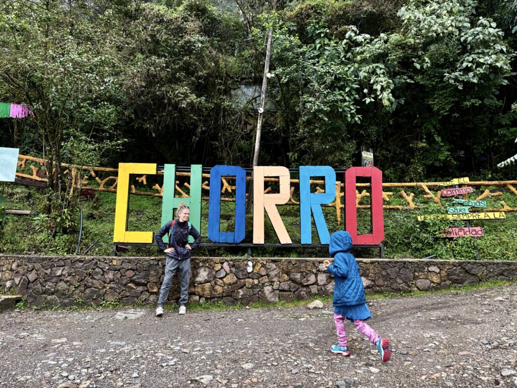 a girl running up to her mother with a sign in the background