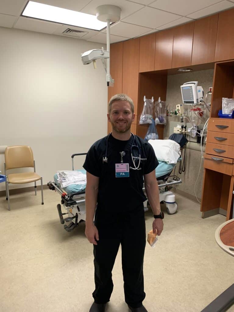 medical provider in scrubs in an emergency department bay