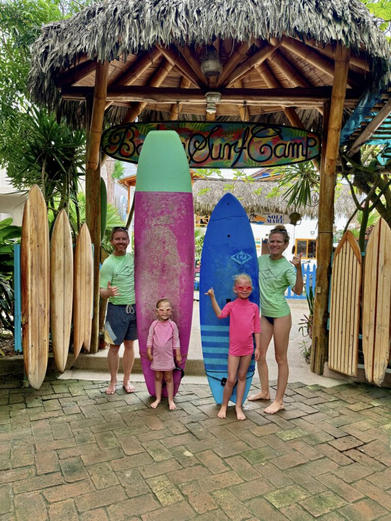 family of four with surf boards