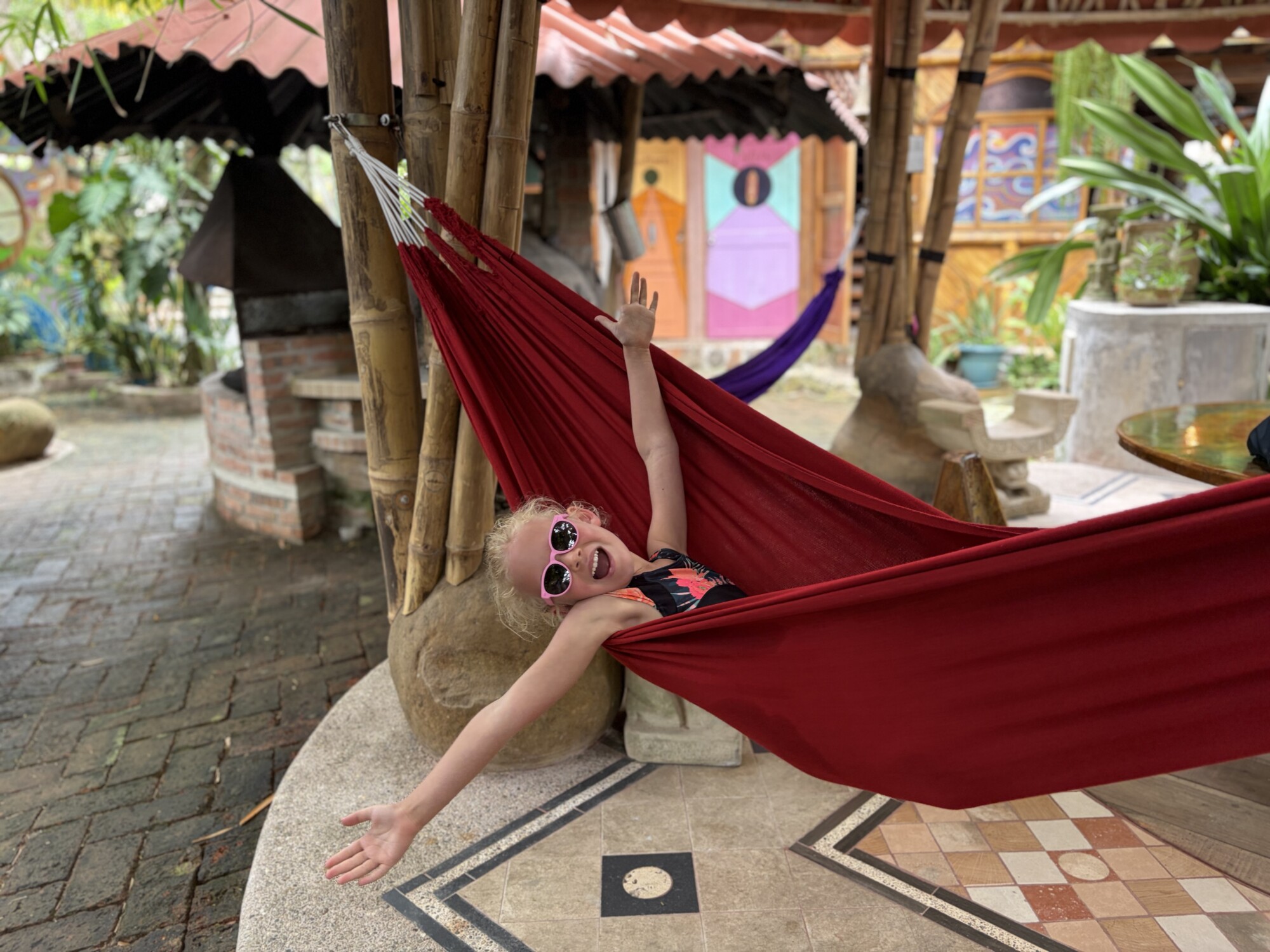 a girl on a hammock with sun glasses