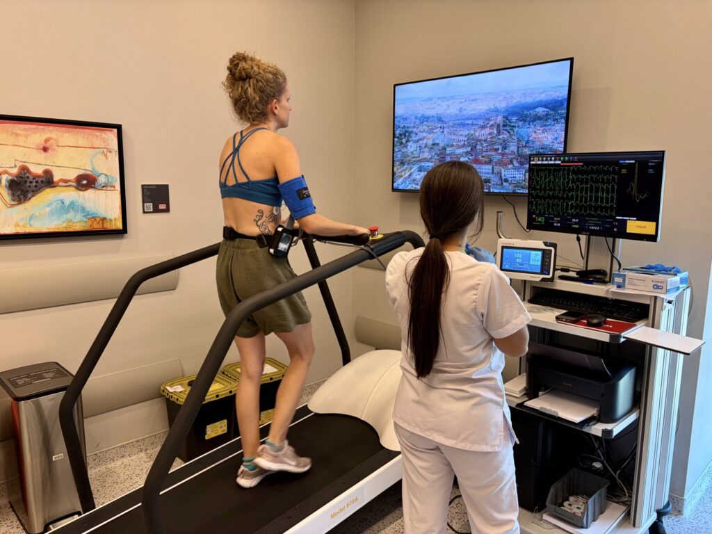 a woman on a treadmill hooked up to medical equipment