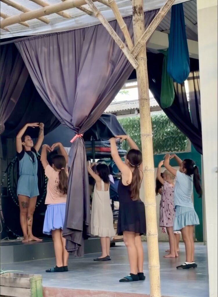 a group of kids in ballet class with an instructor