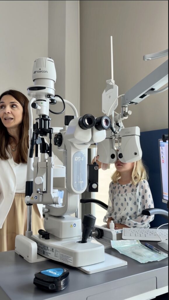 a girl getting her eyes checked by an eye doctor