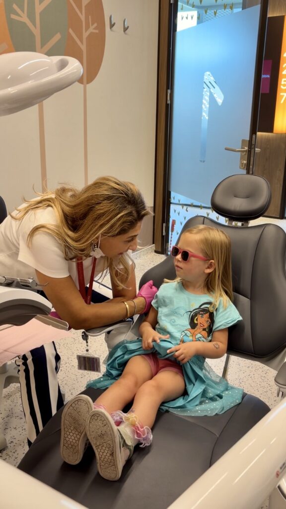 a girl with a dentist getting a check up