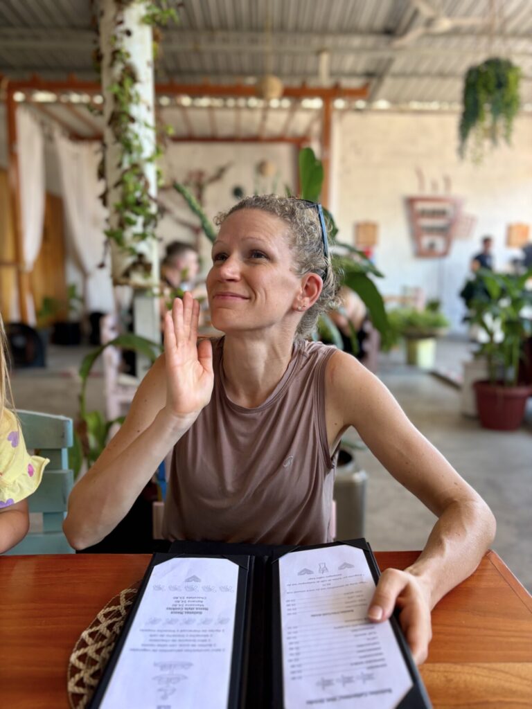 woman sitting at a restaurant with a menu