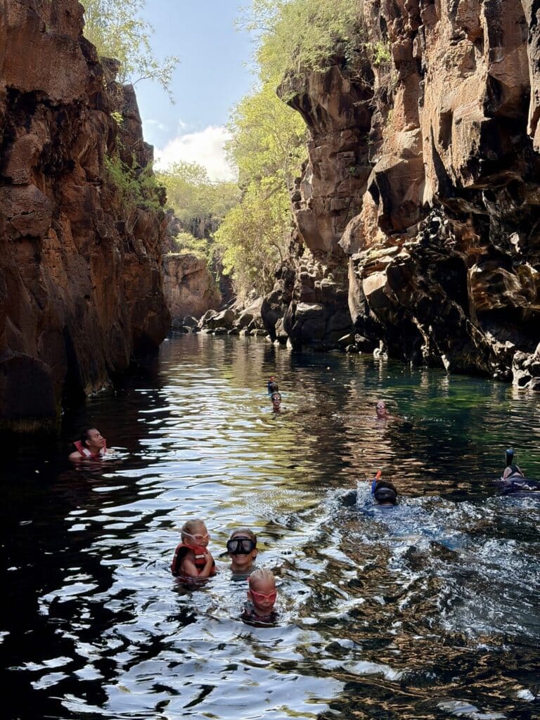 people swimming with canyons on both sides